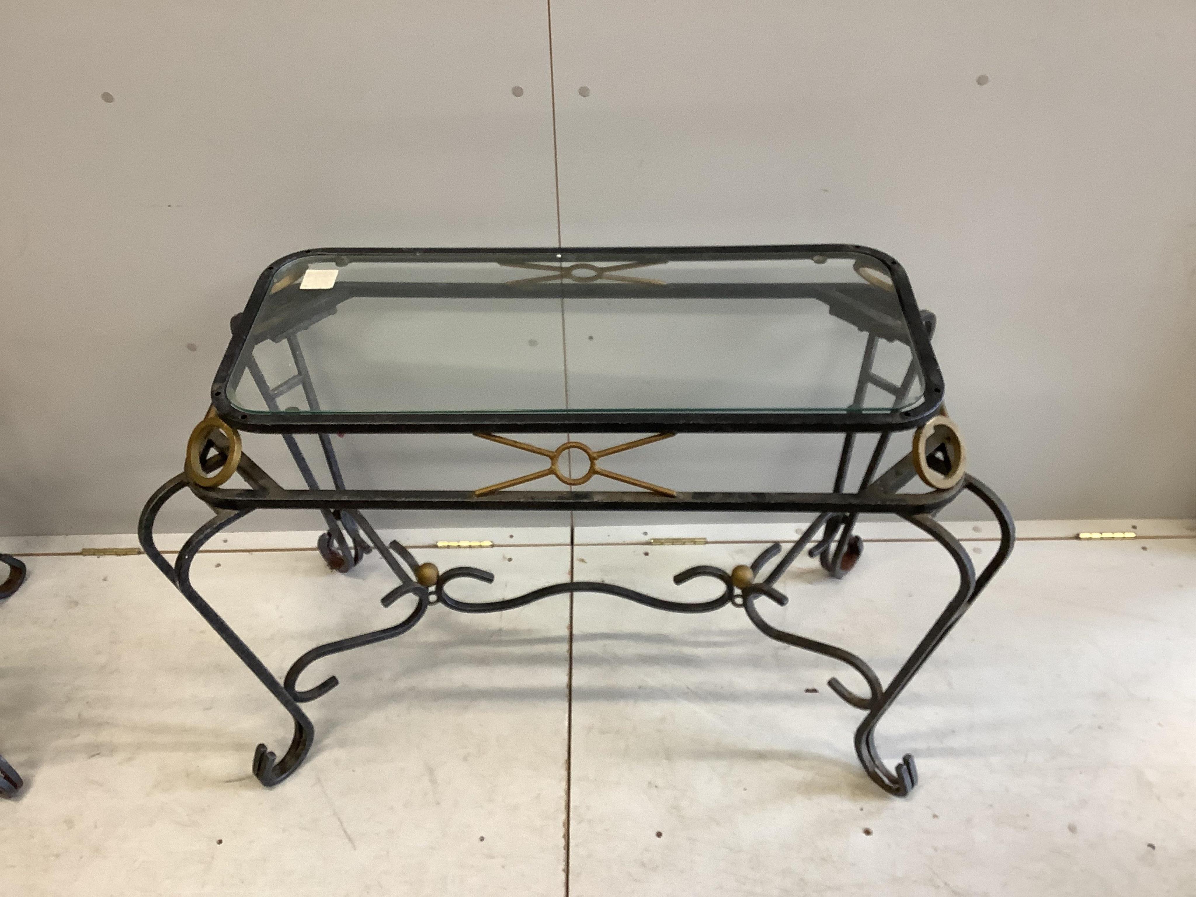 A pair of wrought iron glass top tables, width 106cm, depth 58cm, height 71cm. Condition - fair